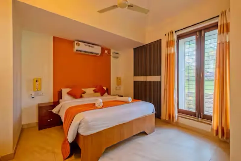 Bedroom with an orange accent wall