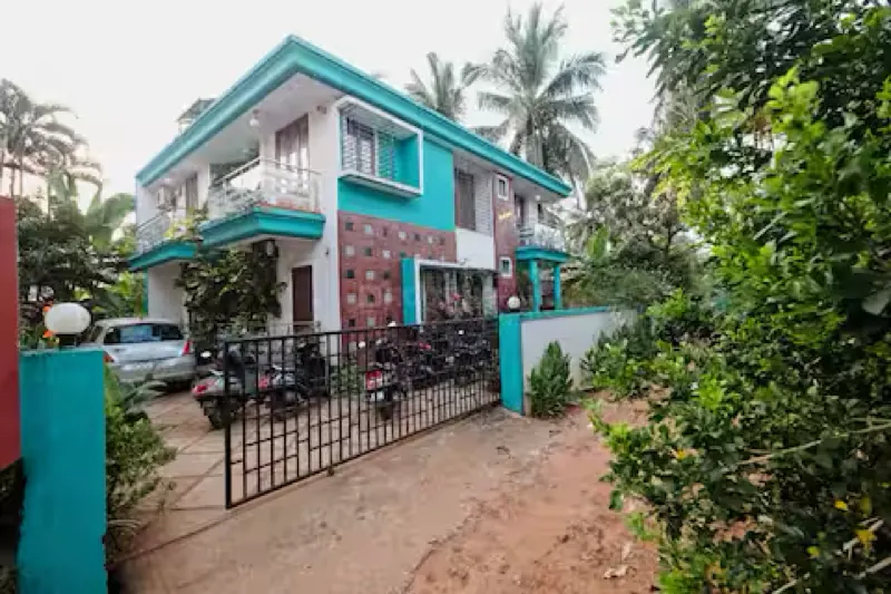 Two storey house in Candolim with a gated driveway