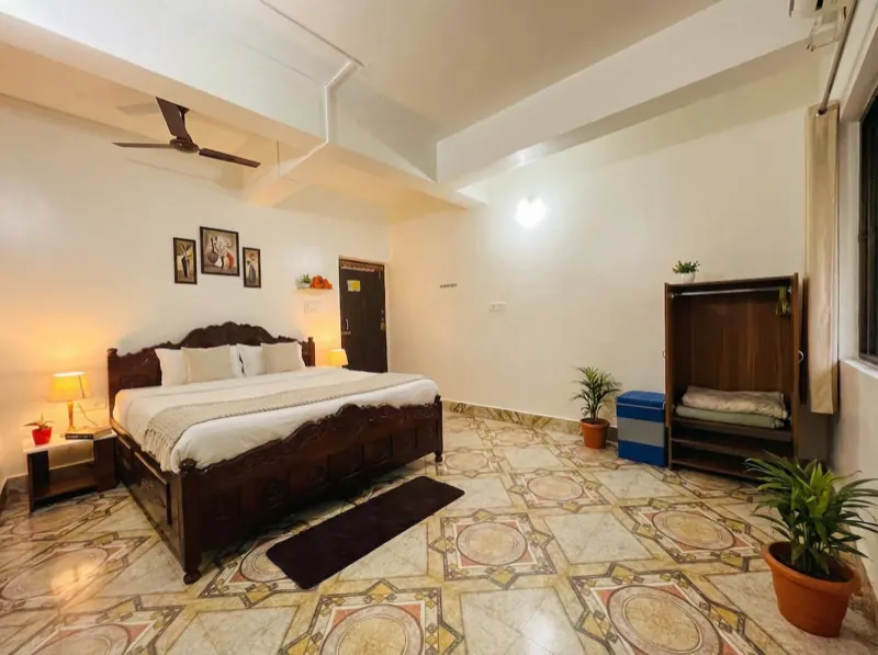 Bedroom with patterned tiles and a king bed