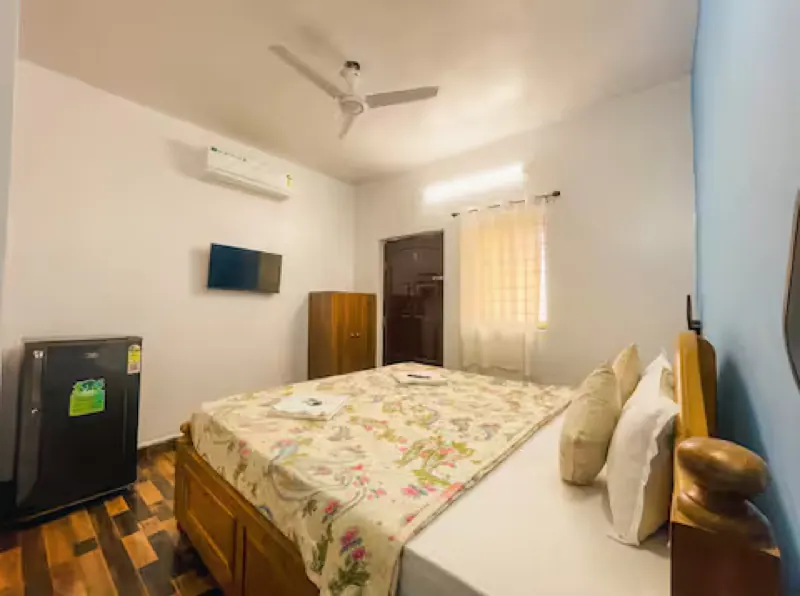 Ensuite bedroom with king bed, fridge and wardrobe