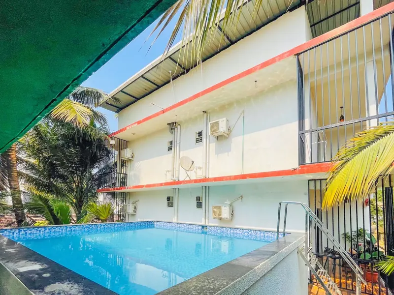 Pool beside the Celeste Stay building, with balconies above