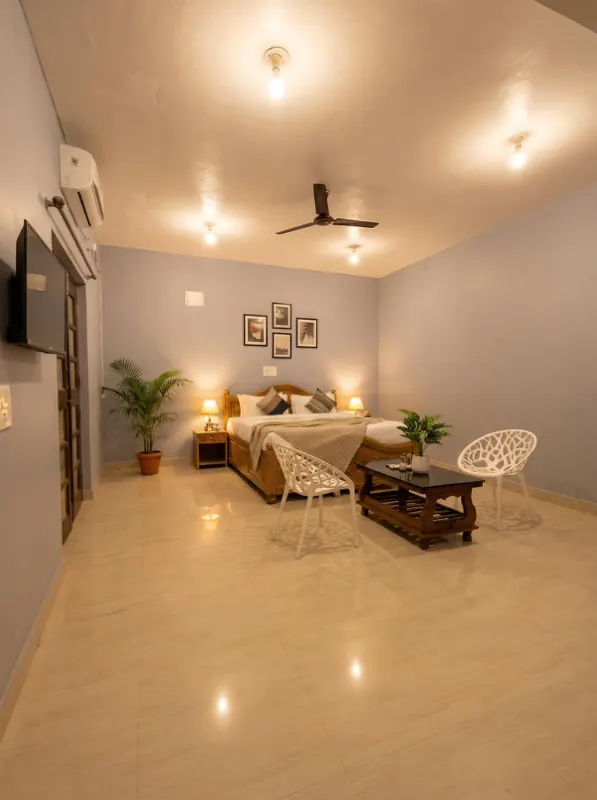Studio room with king bed, seating and wall TV