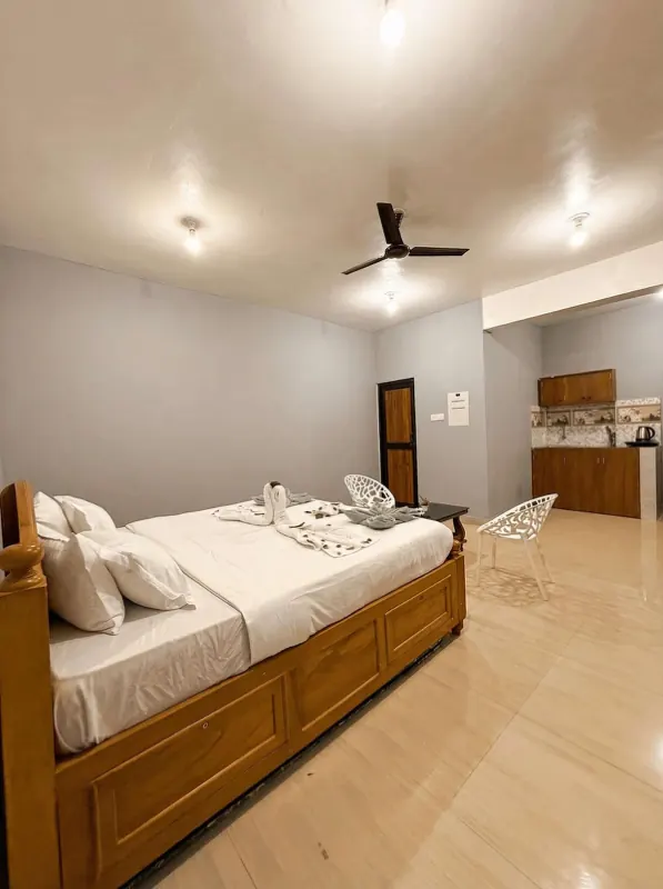 Studio bed with the kitchenette behind it